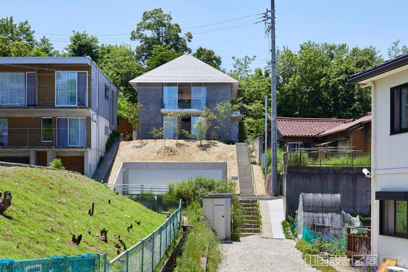 airhouse tops house on a sloping hill in seto, japan, with